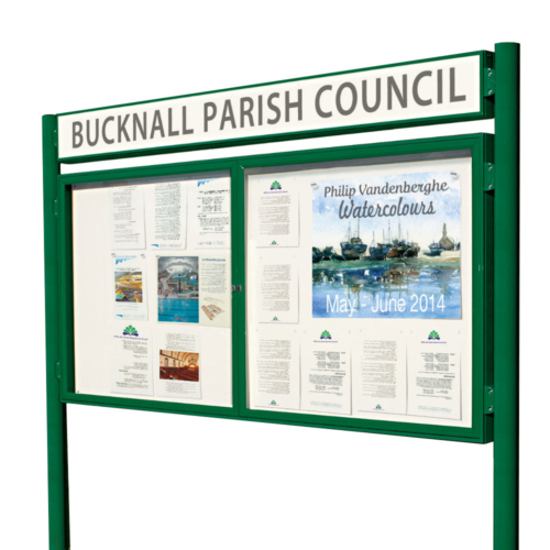 Large green two doored parish notice board with posts and a header board