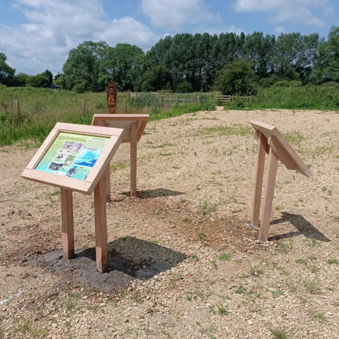 Three oak lecterns arranged in a circle by a field