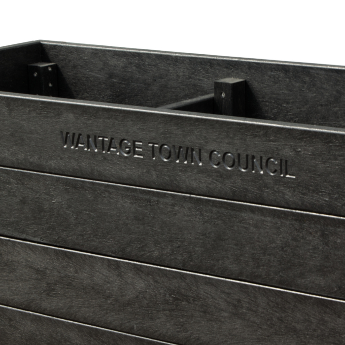 Close up of black blockade planter with engraved words