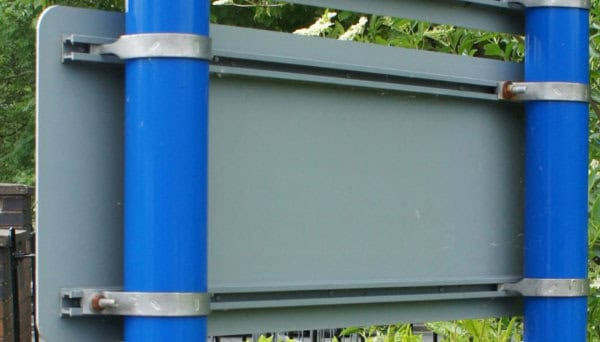 Back view of a sign attached to posts with brackets