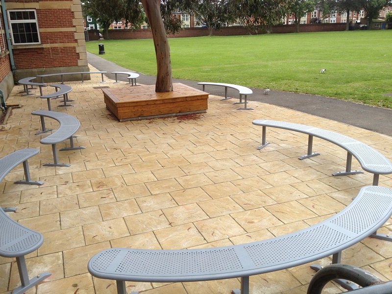 Curved steel benches arranged on paving slabs
