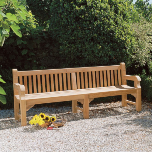 Long 2.4 metre teak outdoor seat on gravel.