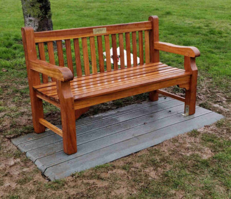 Oiled wooden seat on recycled plastic base. Seat has an engraved plaque on the top bar.