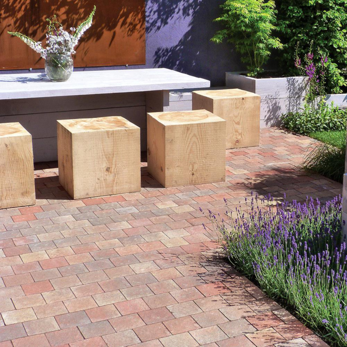 Four oak cube stools in a sunny garden setting