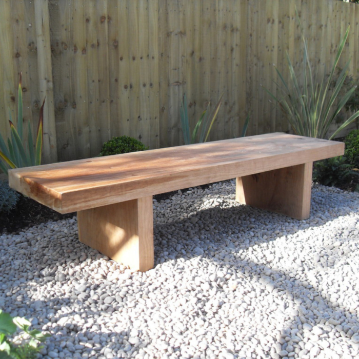 Wide oak bench on gravel