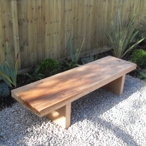 Simple oak bench set on gravel