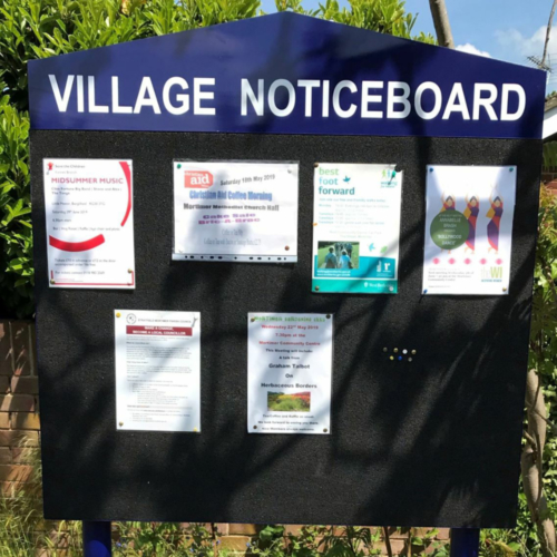 Village bulletin board with header and black pinnable surface