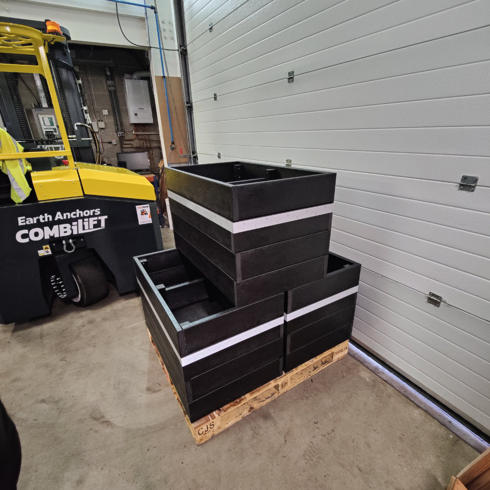 Black recycled plastic planter with reflective tap around the perimeter.