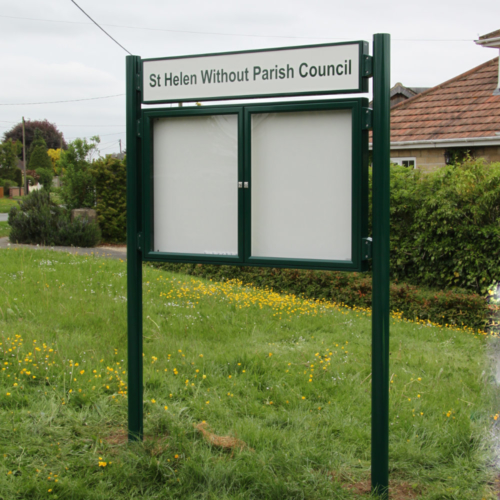 Large two door notice board with posts set in grass