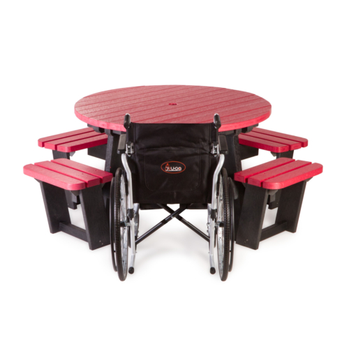 Outdoor picnic bench with wheelchair in place in red and black made from recycled plastic.