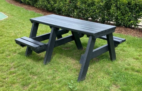 Surrey-1.5m-Mobility-Table-in-Black Black recycled plastic picnic table set in grass with room for a wheelchair