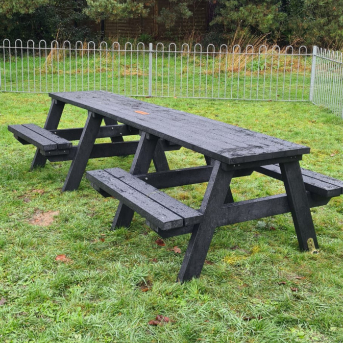 Recycled Plastic Picnic Bench in Black on Grass with a plaque central on the table top