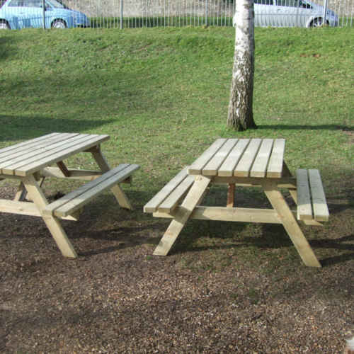 Two A frame timber picnic tables in a park setting