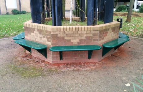 Wall-Mounted-Rangers-1 Green steel benches attached around a hexagonal wall